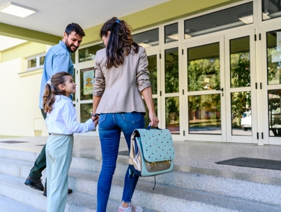 parents dropping off child at school