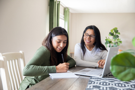 mother and teen daughter doing homework
