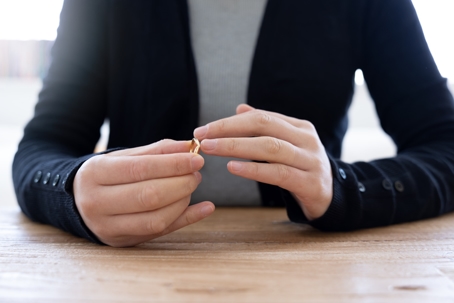 woman taking off wedding ring