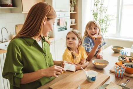 mother and children eating breakfast together